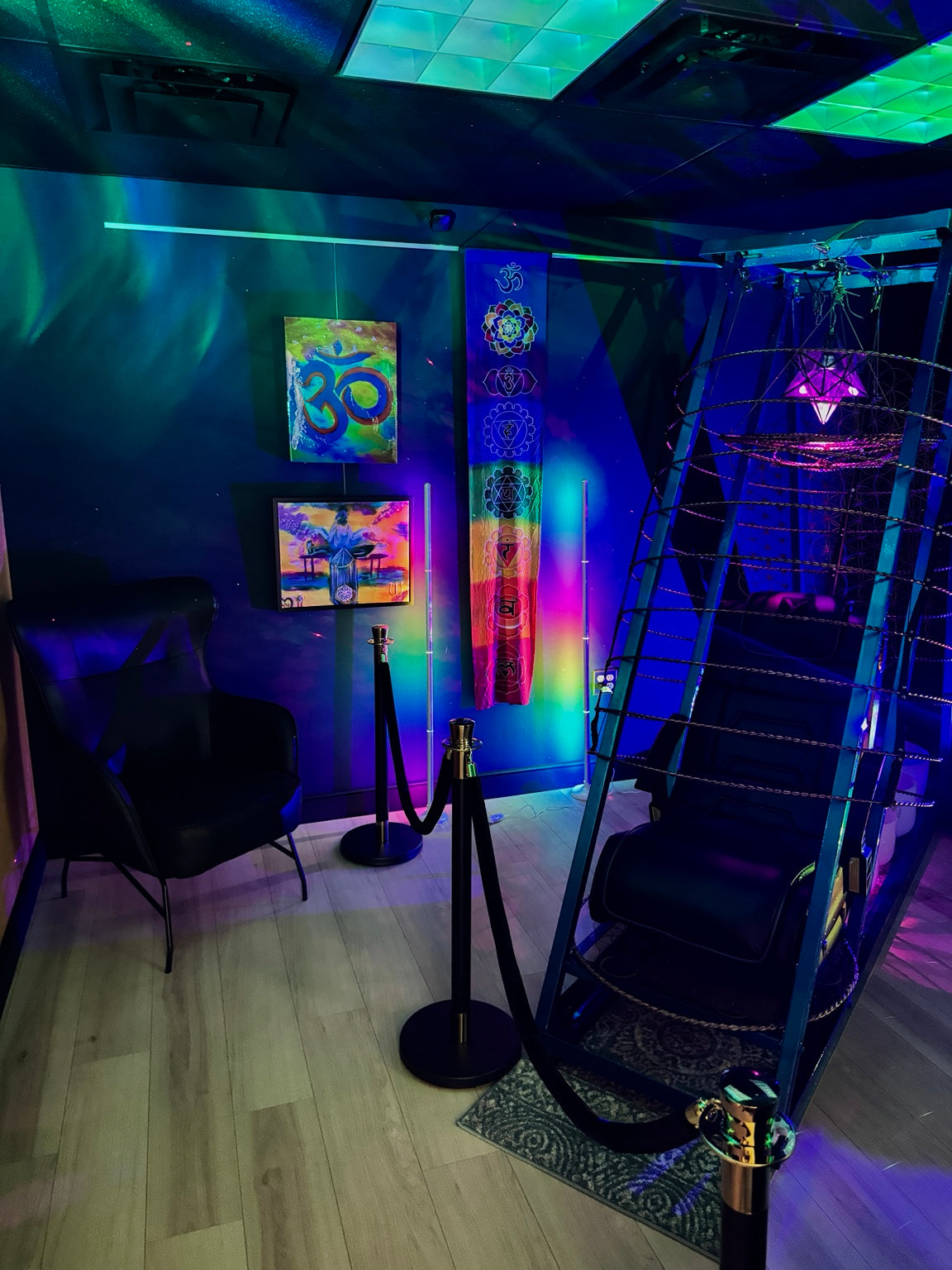 Heartwork Studios meditation room with chamber chair, sound and light installation, artwork, and chakra banner